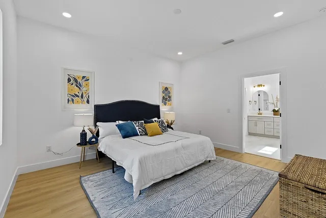 a bedroom with a bed and wooden floor