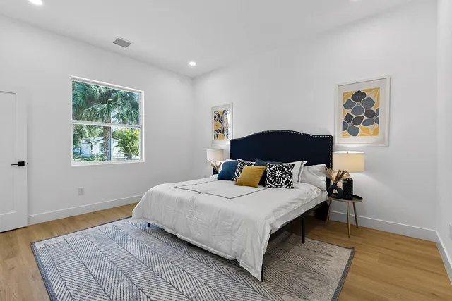 a bedroom with a bed and wooden floor
