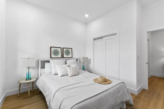 a bedroom with a bed and a painting on the wall