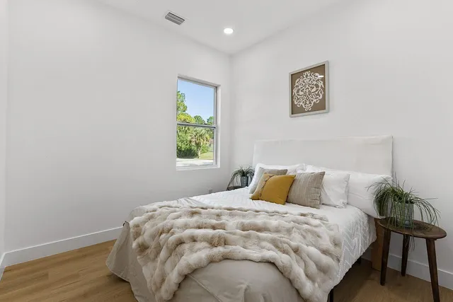 a bedroom with a bed and a window