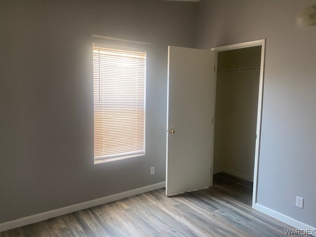 4335 Rafe Avenue Fort Mohave, AZ 86426 - Photo 12 of 22 a view of an empty room with wooden floor and a window