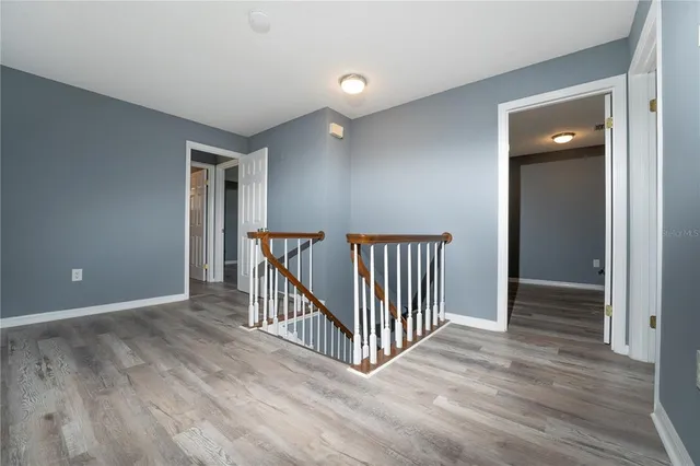 a view of a room with wooden floor and windows