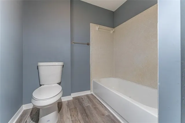 a bathroom with a toilet and a bathtub