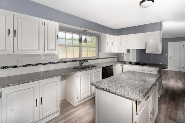 a kitchen with granite countertop white cabinets and a granite counter tops
