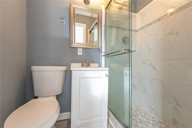 a white toilet sitting next to a bathroom sink