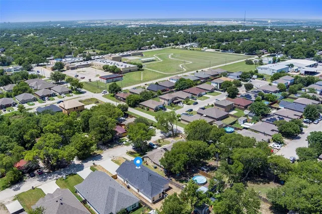 an aerial view of a houses with a yard
