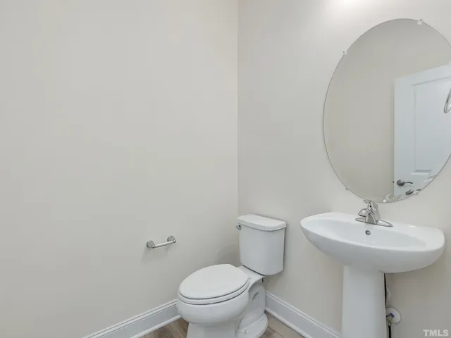 a bathroom with a sink toilet and a mirror