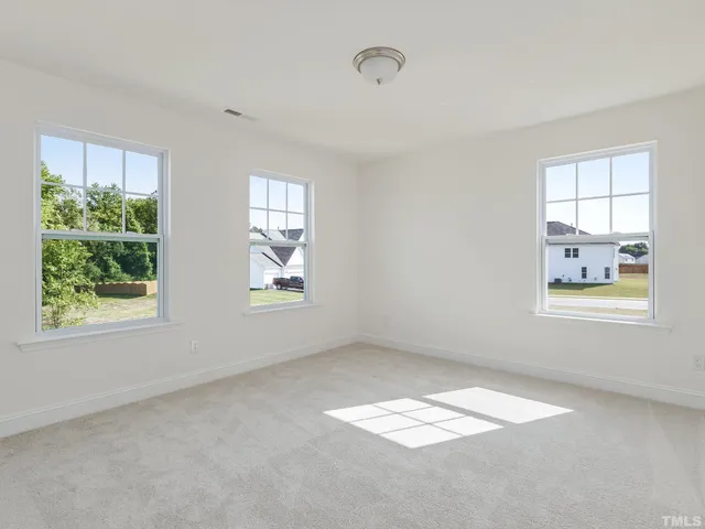 a view of empty room with windows