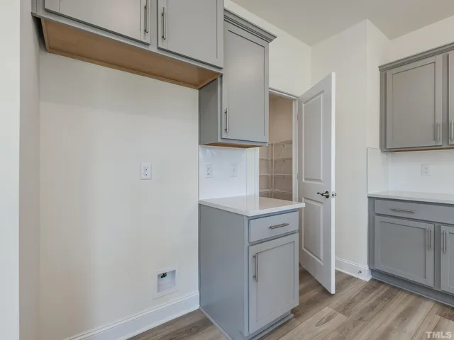 a kitchen with a white cabinets and a refrigerator
