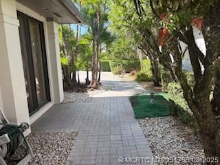 Undisclosed Address Stuart, FL 34997 - Photo 2 of 20 a view of backyard with large trees and plants