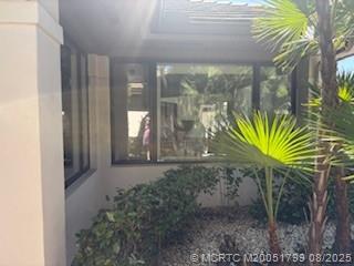 Undisclosed Address Stuart, FL 34997 - Photo 3 of 20 a view of a glass door with a glass door and a yard