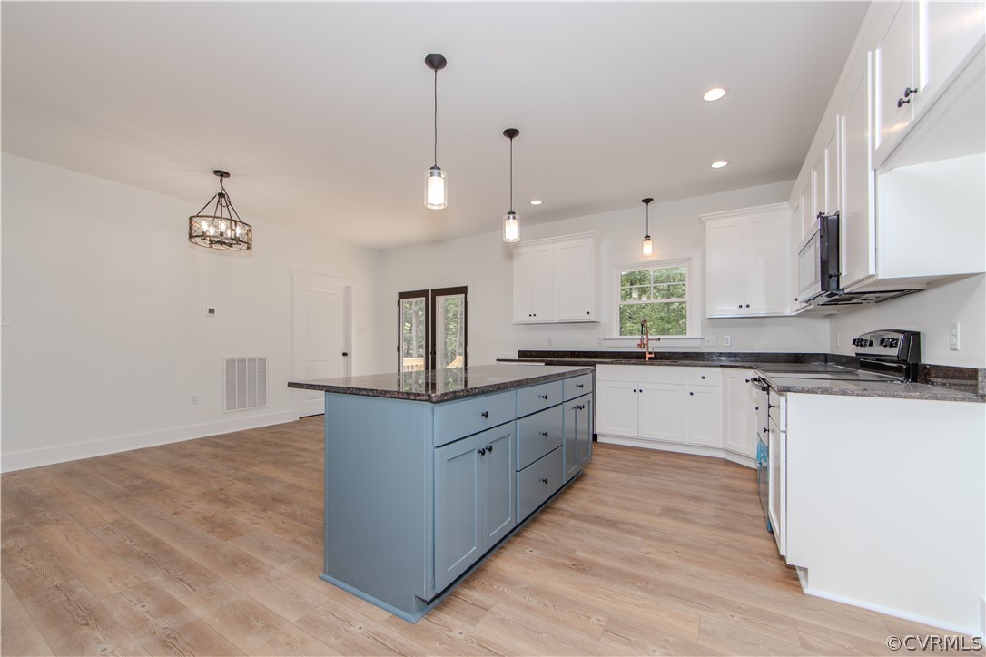 4243 Three Bridge Road Powhatan, VA 23139 - Photo 10 of 32 a large kitchen with granite countertop a large counter top a sink stainless steel appliances and cabinets
