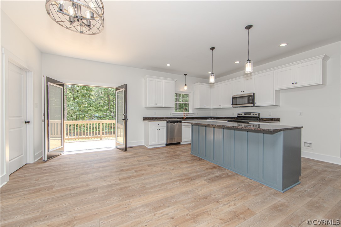 4243 Three Bridge Road Powhatan, VA 23139 - Photo 11 of 32 a kitchen with stainless steel appliances kitchen island granite countertop a stove top oven a sink a counter top space and cabinets