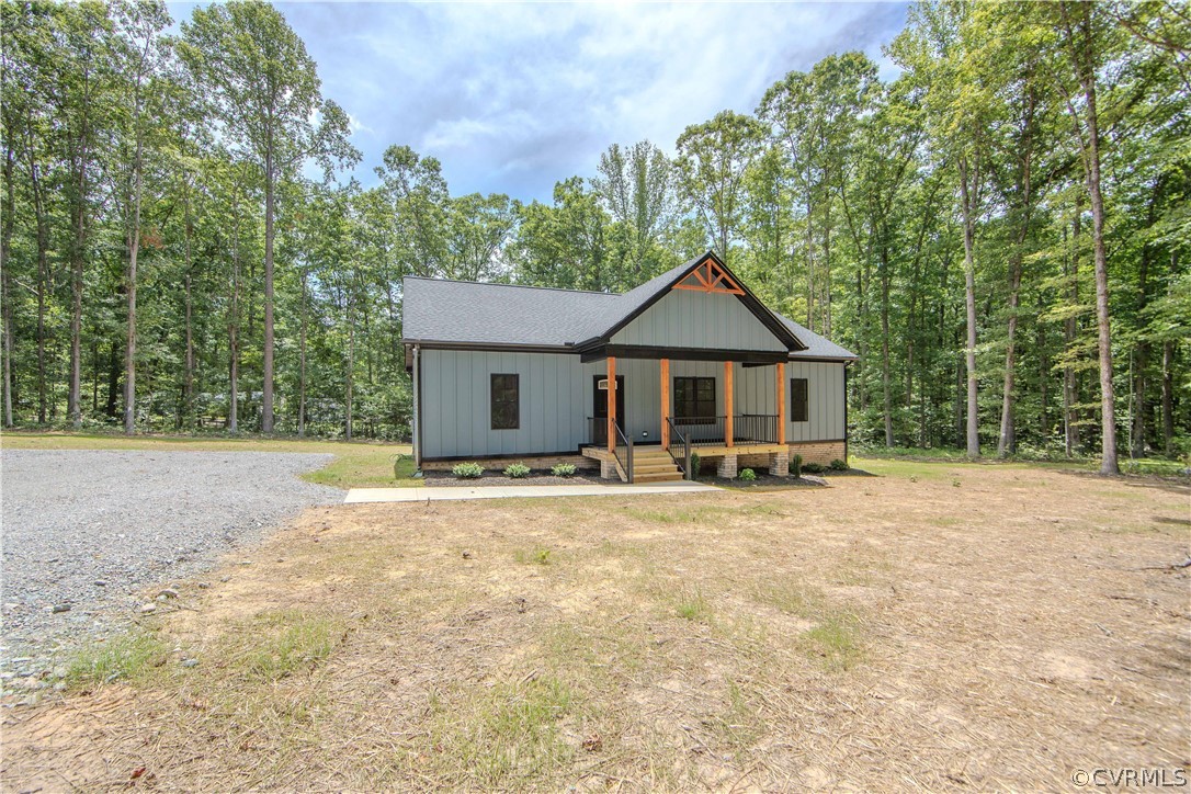 4243 Three Bridge Road Powhatan, VA 23139 - Photo 2 of 32 a front view of a house with yard patio and garage
