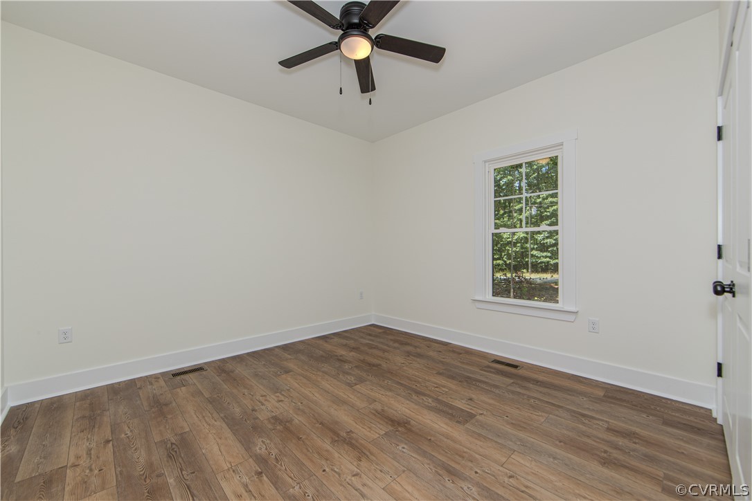 4243 Three Bridge Road Powhatan, VA 23139 - Photo 20 of 32 an empty room with a window and a fan