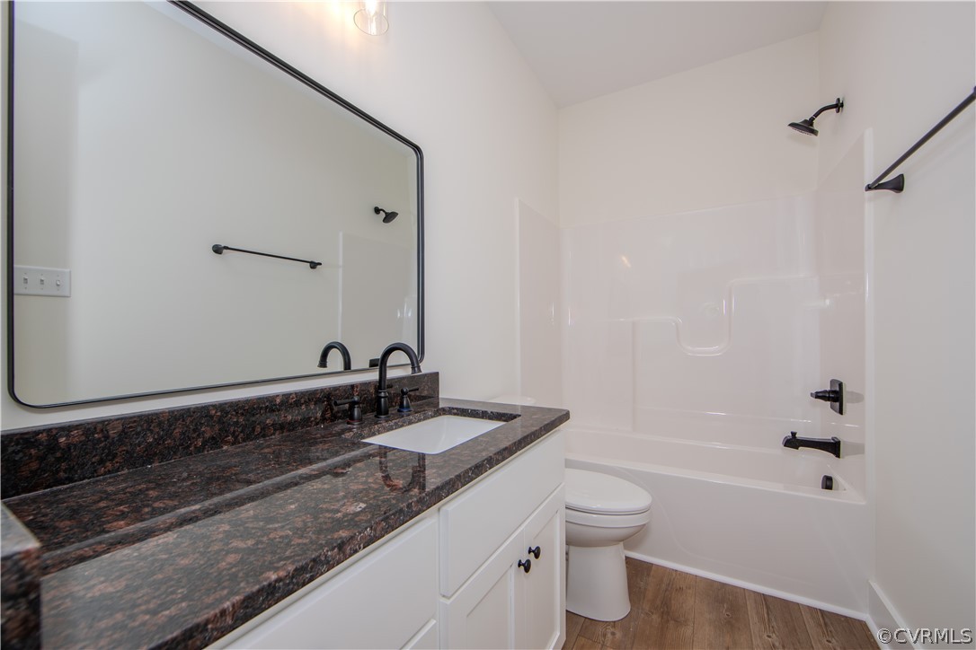4243 Three Bridge Road Powhatan, VA 23139 - Photo 22 of 32 a bathroom with a granite countertop sink a toilet and shower