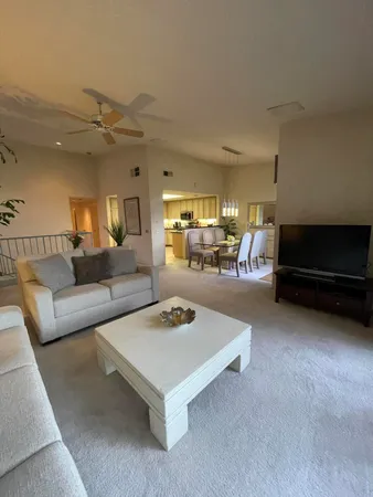a dining room with furniture and a chandelier