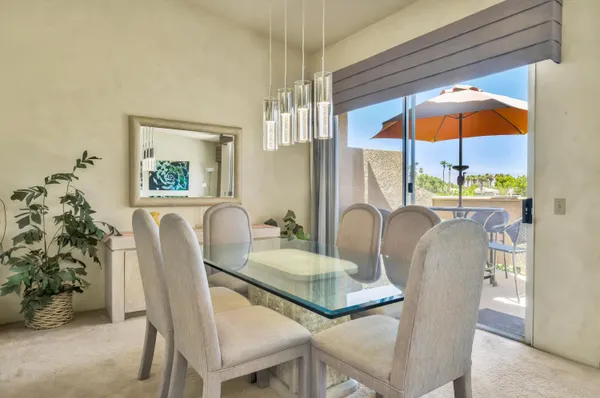 a kitchen with granite countertop a refrigerator a sink a stove top oven and cabinets