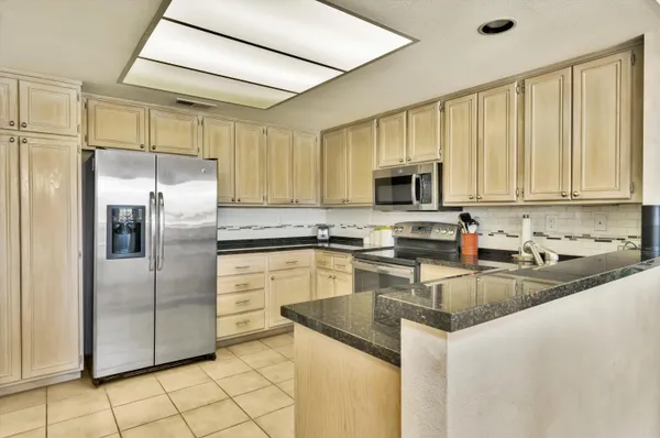 a kitchen with cabinets appliances and a counter top space