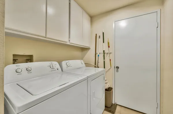a view of a terrace with furniture and umbrella