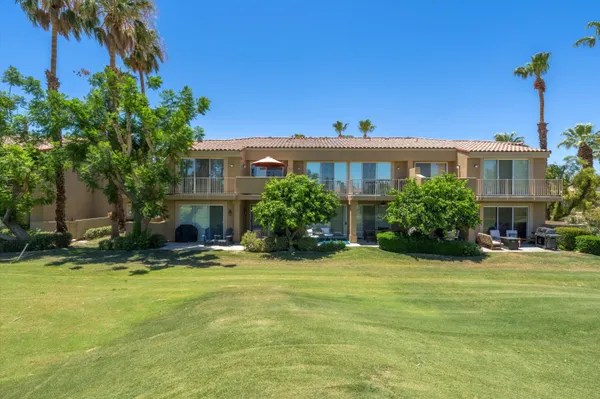 a swimming pool with outdoor seating and yard