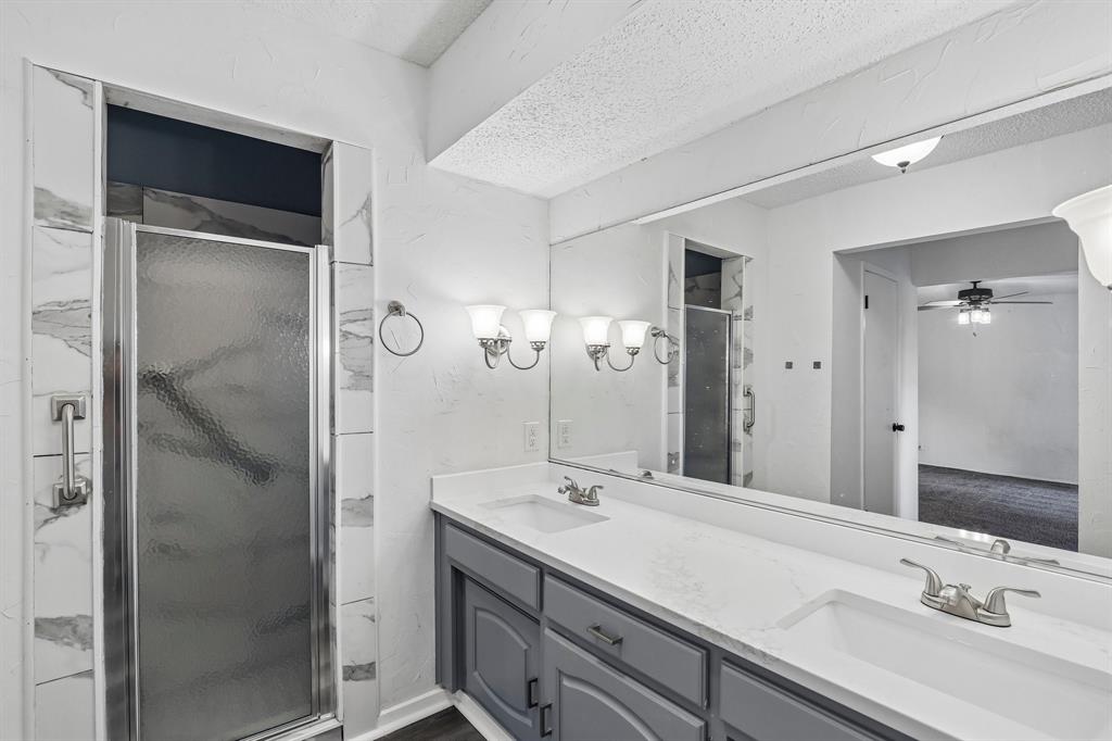 1600 South Timber Court Benbrook, TX 76126 - Photo 22 of 30 Dual vanity with gray cabinetry and white countertops, featuring two integrated sinks with brushed nickel faucets
