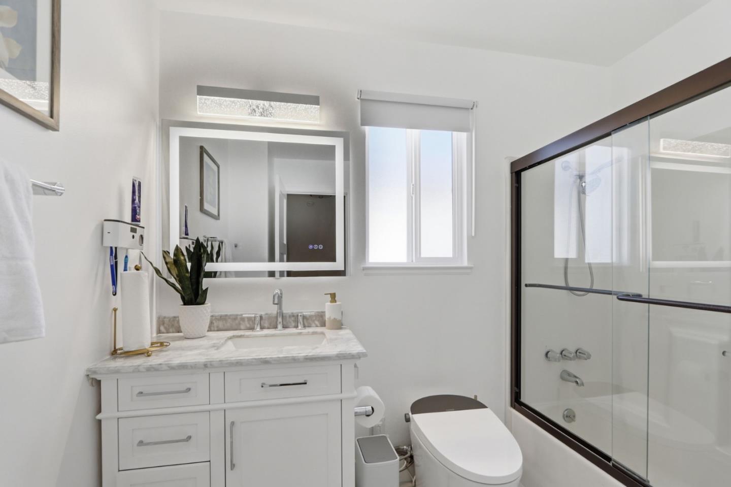 5888 Lean Way San Jose, CA 95123 - Photo 44 of 54 a bathroom with a granite countertop sink toilet a mirror and shower