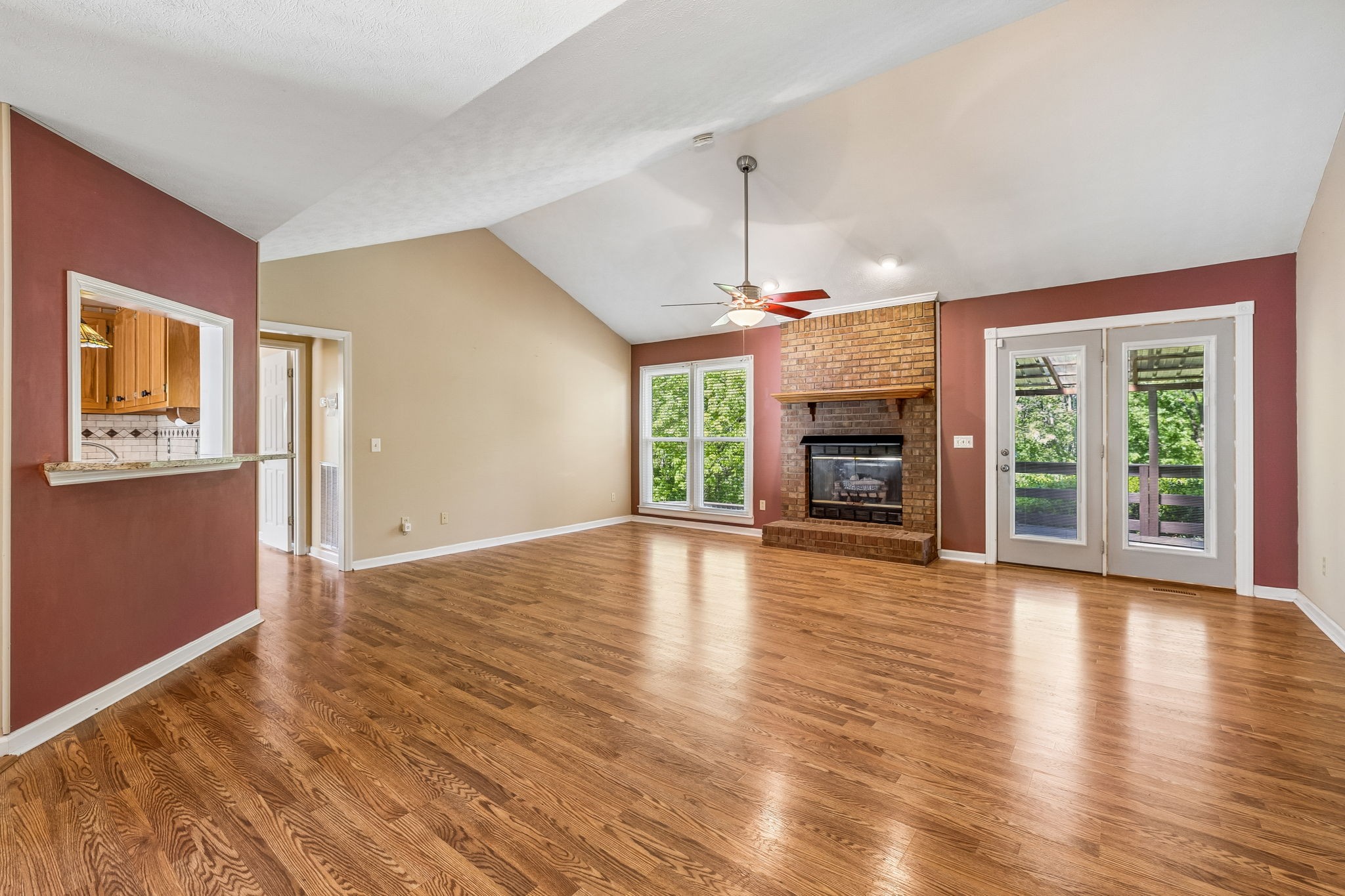 107 Keri Drive Pleasant View, TN 37146 - Photo 11 of 40 a view of an empty room with wooden floor fireplace and a window