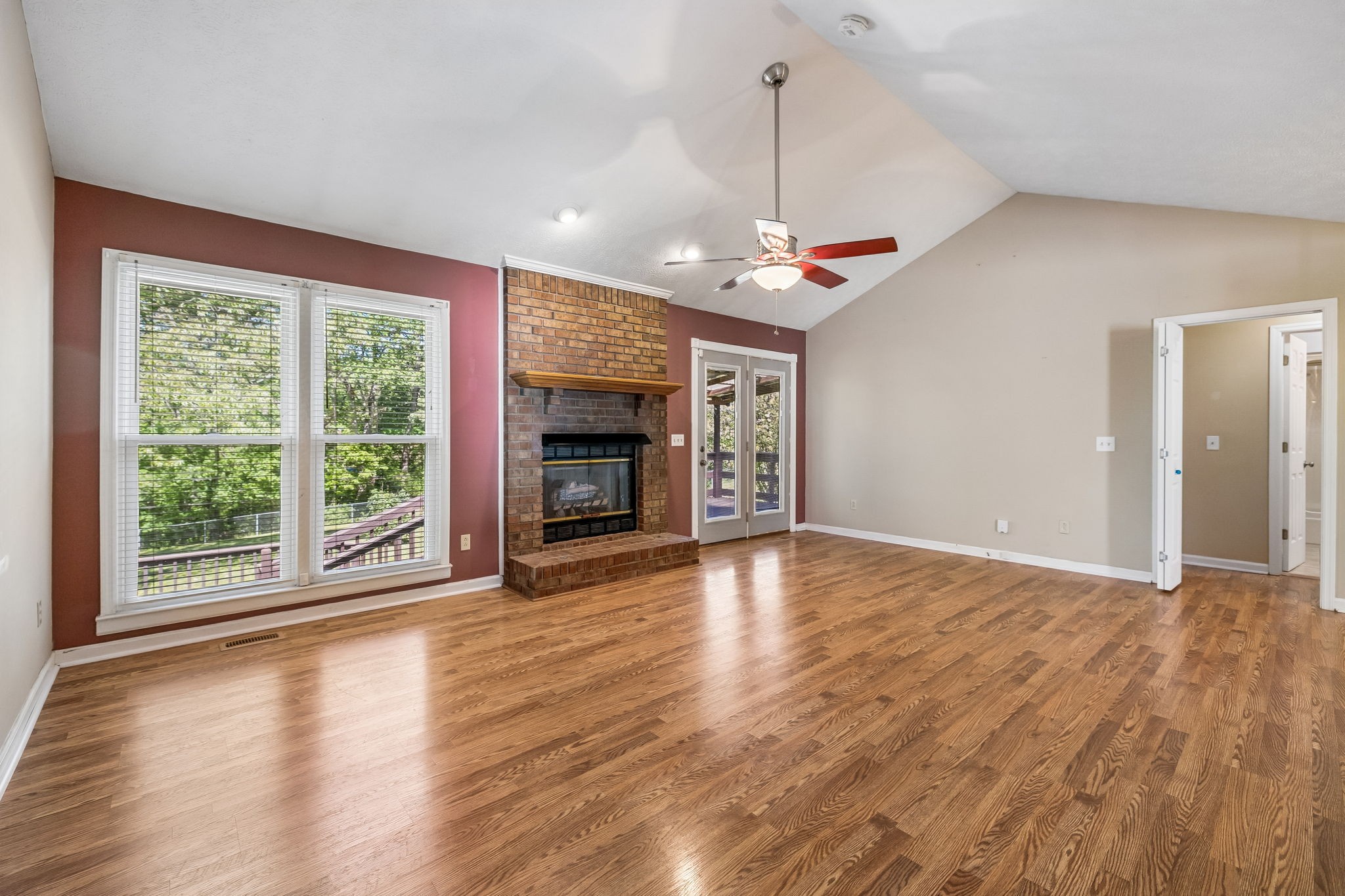 107 Keri Drive Pleasant View, TN 37146 - Photo 14 of 40 a view of an empty room with wooden floor fireplace and a window