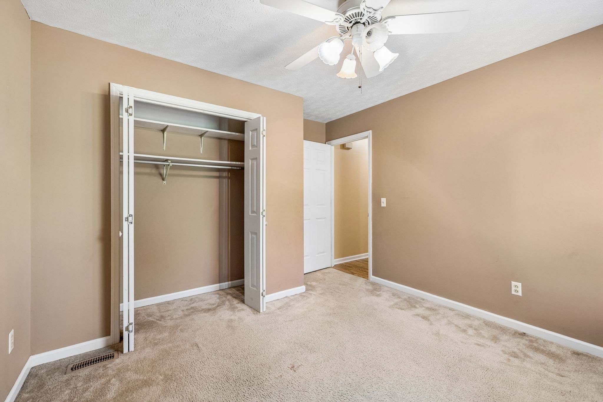 107 Keri Drive Pleasant View, TN 37146 - Photo 18 of 40 an empty room with closet and a chandelier fan