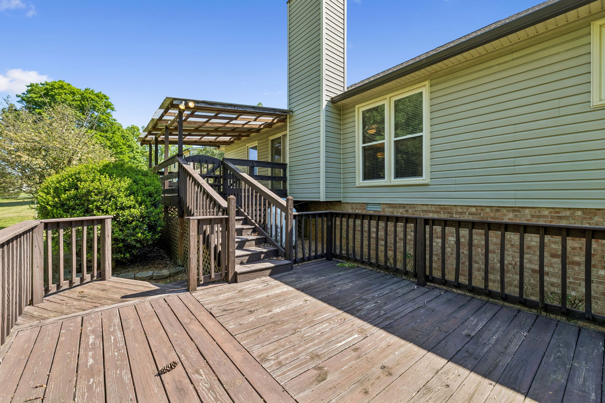 107 Keri Drive Pleasant View, TN 37146 - Photo 35 of 40 a porch with wooden floor stairs and a potted plant