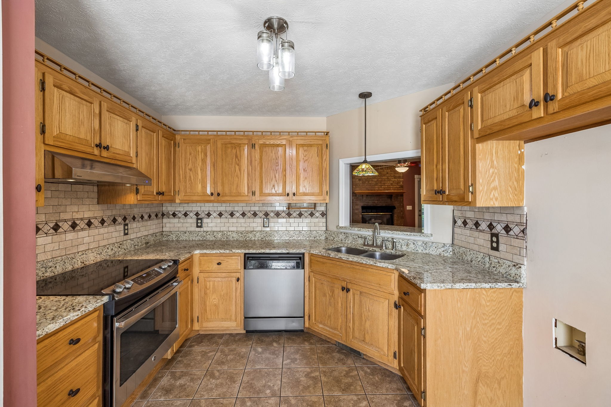 107 Keri Drive Pleasant View, TN 37146 - Photo 6 of 40 a kitchen with stainless steel appliances granite countertop a stove a sink dishwasher and a microwave oven with cabinets