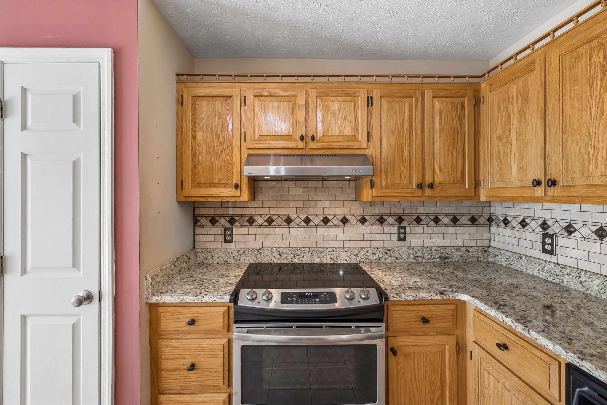 107 Keri Drive Pleasant View, TN 37146 - Photo 8 of 40 a kitchen with granite countertop a sink stove and cabinets