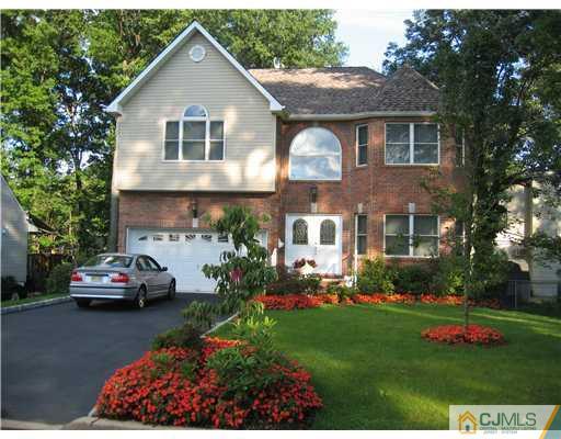 5 West Hill Road Colonia, NJ 07067 - Photo 1 of 7 a front view of a house with a garden and plants