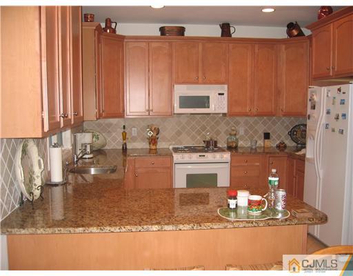 5 West Hill Road Colonia, NJ 07067 - Photo 2 of 7 a kitchen with a refrigerator and a sink