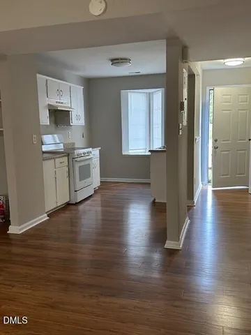 a view of a kitchen cabinets wooden floor and a window