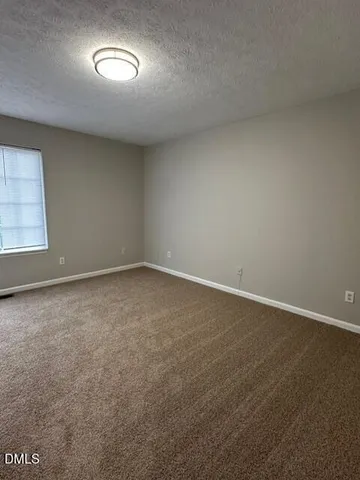 an empty room with a empty space and windows