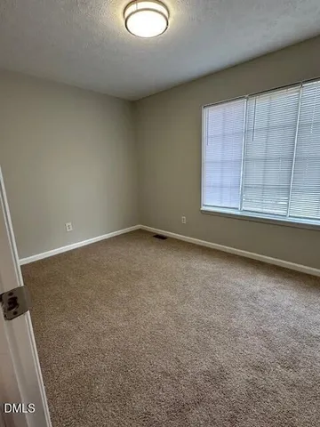an empty room with a empty space and windows