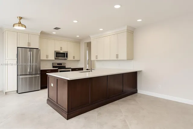 a kitchen with a sink cabinets stainless steel appliances and a counter top
