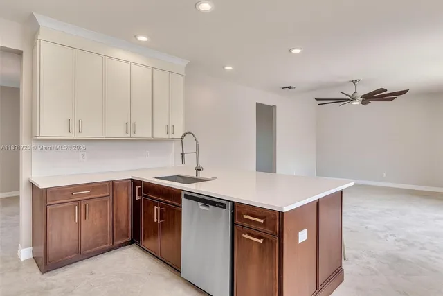 a kitchen with a sink dishwasher and cabinets