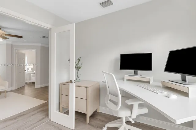 a hallway with a computer on a desk and chair
