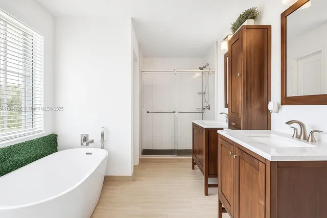 a bathroom with a tub sink and mirror