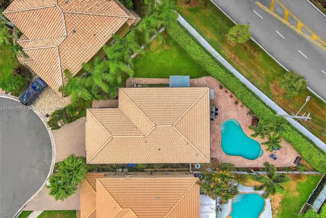 an aerial view of house with yard
