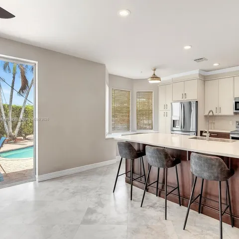 a kitchen with a table and chairs in it