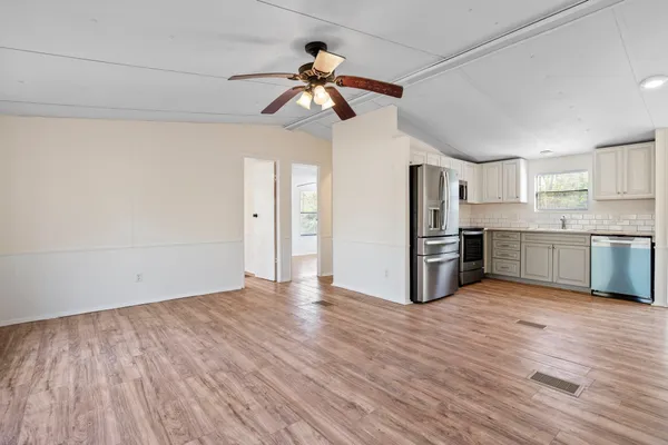 a view of a kitchen with wooden floor and a kitchen