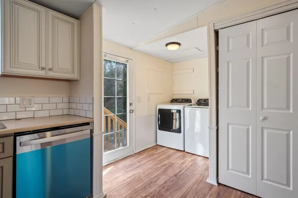 a kitchen with granite countertop a sink and a refrigerator