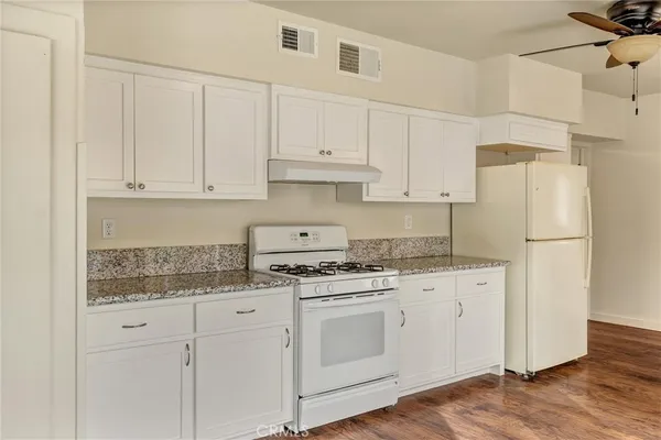a kitchen with appliances a sink and cabinets