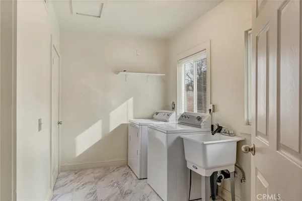 a room with a sink cabinets and a window