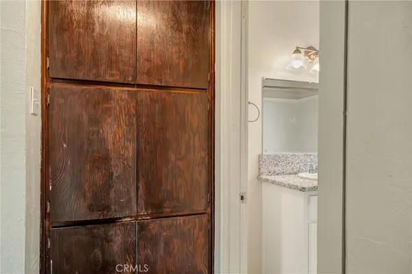 a view of walk in closet with empty racks