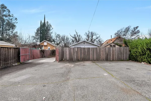 a view of a house with wooden fence